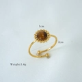 Detail of adjustable gold ring featuring a brown natural stone with beaded edge detail - Tiger Eye