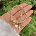 Travel-themed 18K gold-plated snake chain charm bracelet with sparkling airplane pendants - Travel Airplane Globe Postcard Style