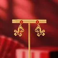 Macro view of 18K gold plated horse pendant earrings with festive red coin studs - 43# Gold Cartoon Horse with Red Fu Coin Studs (Pair)
