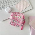 Detail of pink floral quilted sanitary napkin pouch with Sozakka label on white desk - Pink Floral