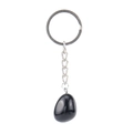 Macro detail of a polished black natural stone keychain with silver metal chain on white - Obsidian