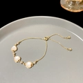 Pulsera dorada ajustable con tres colgantes de corazón de concha y detalles brillantes - S352 Oro - Pulsera de Corazón Ojo de Gato