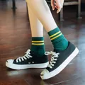 Knee-high dark green cotton ribbed socks with yellow stripes paired with canvas shoes - Double Stripe Socks (Dark Green)
