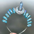 Detailed view of handmade blue crystal crown with silver moon ornament on metal headband - Blue