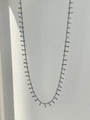 Detailed view of silver tone chain necklace with textured cylindrical charms and tassels - Tassel Style / Silver