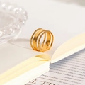 Close-up of 18k gold-plated stainless steel ring with braided textures on a book - 3-Layer Smooth Surface Open Ring