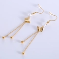 Pendientes de mariposa dorados en acero inoxidable con borlas largas y cuentas mates - Dorado