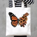 White canvas tote bag featuring butterfly and orange flower print worn by model - Orange Flower Butterfly (STD707-C)