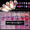 Macro detail of 21-grid nail art rhinestones set with dual-ended picker dotting pen tool - Pink AB + Big Red AB Set