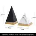 Modern geometric pyramid sculpture set in matte black and marble finish with gold base - A Set Of Geometric Pyramids