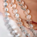 Macro shot of faceted crystal heart beads showing intricate geometric cuts and light refraction - Clear