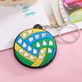 Close-up of blue, green, and yellow rubber volleyball keychain with metal ring and chain - Volleyball