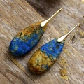 Macro shot of Bohemian water drop earrings with blue and brown stone texture on wood - Blue Brown Stone Gold Color Hook