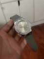 Macro shot of silver quartz watch featuring rhinestone bezel and grey silicone strap - Silver Case Grey Silicone Strap