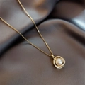 Elegant gold necklace featuring interlocking pavé rings and a center pearl on silk - Gold - Wrapped Pearl Necklace (O-chain)