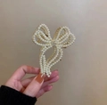 Detail of elegant gold flower hair claw clip with dangling pearls and crystal accents - Bowknot Pearl Claw Clip