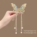 Detail of golden butterfly hair claw with 11cm pearl tassels and colorful gems - Colorful Gemstone Butterfly