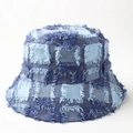 Detail of vintage denim patchwork bucket hat featuring frayed edges and street style design - M (56-58cm) / Blue