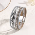 Close-up of bohemian multilayer leather bracelet with silver accents and magnetic clasp - Silver