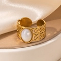 Macro shot of gold hollow ring with oval white iridescent stone and woven details - Braided White Oval Stone Adjustable Style (TYR0823)