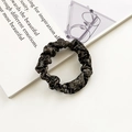 Glossy silk-like scrunchie in dark brown with textured fabric on a white surface - Black Brown Irregular Texture