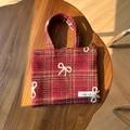 Detail of red plaid tweed handbag featuring a white woven bow and simple wish label - Dark Red Plaid with Bow