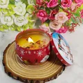 Christmas scented candle in a red tin with Santa Claus and reindeer holiday patterns - D221 Goji Blood Orange