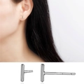 Minimalist S999 sterling silver bar stud earrings showing S999 hallmark and model fit - T-Shaped Studs