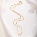 Detail of a 18k gold plated twist chain necklace with star motifs on a stone tray - A0153 Embossed Link Chain