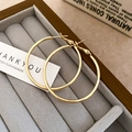 Detail of round gold hoop earrings resting on a grey velvet jewelry organizer box - Diameter 50mm / Gold
