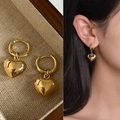 Elegant gold heart pendant earrings shown on model and in a premium textured gift box - Gold Heart Pendant