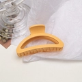 Macro shot of large matte yellow shark hair claw clip on white textured paper - Semi-circle / Milky Yellow