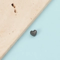 Macro view of a 1mm hole stainless steel heart pendant with scalloped edge detail - Black