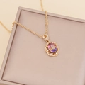 Detail of gold sunflower necklace with purple gradient stone on beige jewelry box - Rainbow