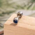 Silver geometric conch piercing stud with a round blue zircon on a wood texture - Royal Blue (Single)
