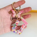 Detail of resin letter U keychain with pink glitter butterfly and heart sequins - Butterfly Tassel 8-Shape Buckle / Letter U