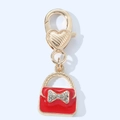 Detail of red handbag keychain with rhinestone bow and gold heart lobster clasp - Bag