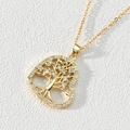 Detailed view of a golden heart-shaped Tree of Life pendant with sparkling cubic zirconia - Style E-Heart Hollow White Zircon