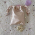 Pink satin silk drawstring bag for jewelry and cosmetics storage shown on mesh background - 15.5*11.5 / Nude Pink