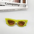 Detailed top view of retro cat-eye sunglasses in neon green on a modern white background - Jelly Green