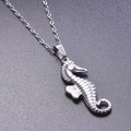 Macro dettagliata di un ciondolo a forma di cavalluccio marino in argento su nero - Collana / Argento