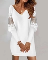 Detailed close-up of V-neckline and intricate lace patchwork on white long-sleeve dress - S / White