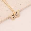 Detail of gold butterfly necklace with black enamel and zircon stones on stone background - Black