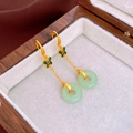 Detail of gold butterfly earrings with green faux jade pendant on a wooden box - Green Butterfly Geometric Ear Hook