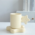 Cream yellow ceramic mug with starry handle and matching star-shaped saucer base - Star Cup & Saucer - Apricot
