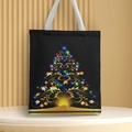 Detail of a black Christmas canvas tote bag featuring a golden tree and white handle - Style 4