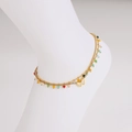 Double-layered golden anklet with butterfly pendant and colorful beads on white background - Anklet