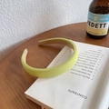 Minimalist lime green padded fabric headband displayed on an open vintage book - Thickened Padded Fabric Style / Lemon Green