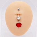 Macro shot of silver navel ring with a sparkling clear gem and red heart pendant - Red Heart