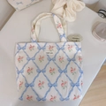 Flat lay of floral canvas tote bag with blue bow patterns and simple wish brand label - Light Blue Bow Quilted Small Rose